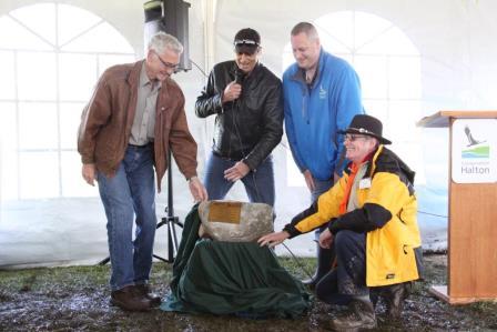 From left, Conservation Halton Chair John Vice, Halton Regional Chair Gary Carr, Conservation Halton CAO Ken Phillips and Deputy Area Commissioner for the Scouts Bob Collison unveil a commemorative plaque and rock which will remain on-site in recognition of the planting.